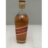 A LITRE BOTTLE OF JOHNNIE WALKER RED LABEL OLD SCOTCH WHISKY