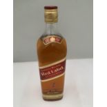 A LITRE BOTTLE OF JOHNNIE WALKER RED LABEL OLD SCOTCH WHISKY