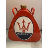 A RED MASERATI PETROL CAN WITH BRASS STOPPER