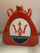 A RED MASERATI PETROL CAN WITH BRASS STOPPER