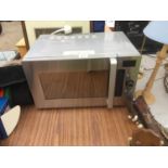 A SILVER DAEWOO MICROWAVE OVEN