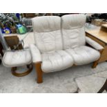 A STRESSLESS RECLINER, TWO SEATER SETTEE AND STOOL