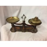 A SET OF CAST IRON VINTAGE AVERY SCALES WITH WEIGHTS AND MAKERS NAME