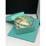 A MARKED 925 FASHION TRI COLOUR INTERLOCKING BANGLE GROSS WEIGHT 52.7 GRAMS WITH GIFT BOX AND BAG