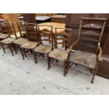 SIX MACCLESFIELD LADDER BACK DINING CHAIRS, ONE BEING A CARVER, ALL WITH RUSH SEATS