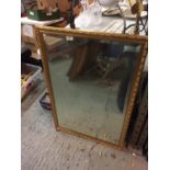 A GILT FRAMED MIRROR