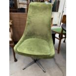 A 1970'S RETRO GREEN SWIVEL CHAIR ON CHROME BASE