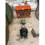 A RAACO STORAGE UNIT, AN OIL CAN AND AN INSPECTION LAMP