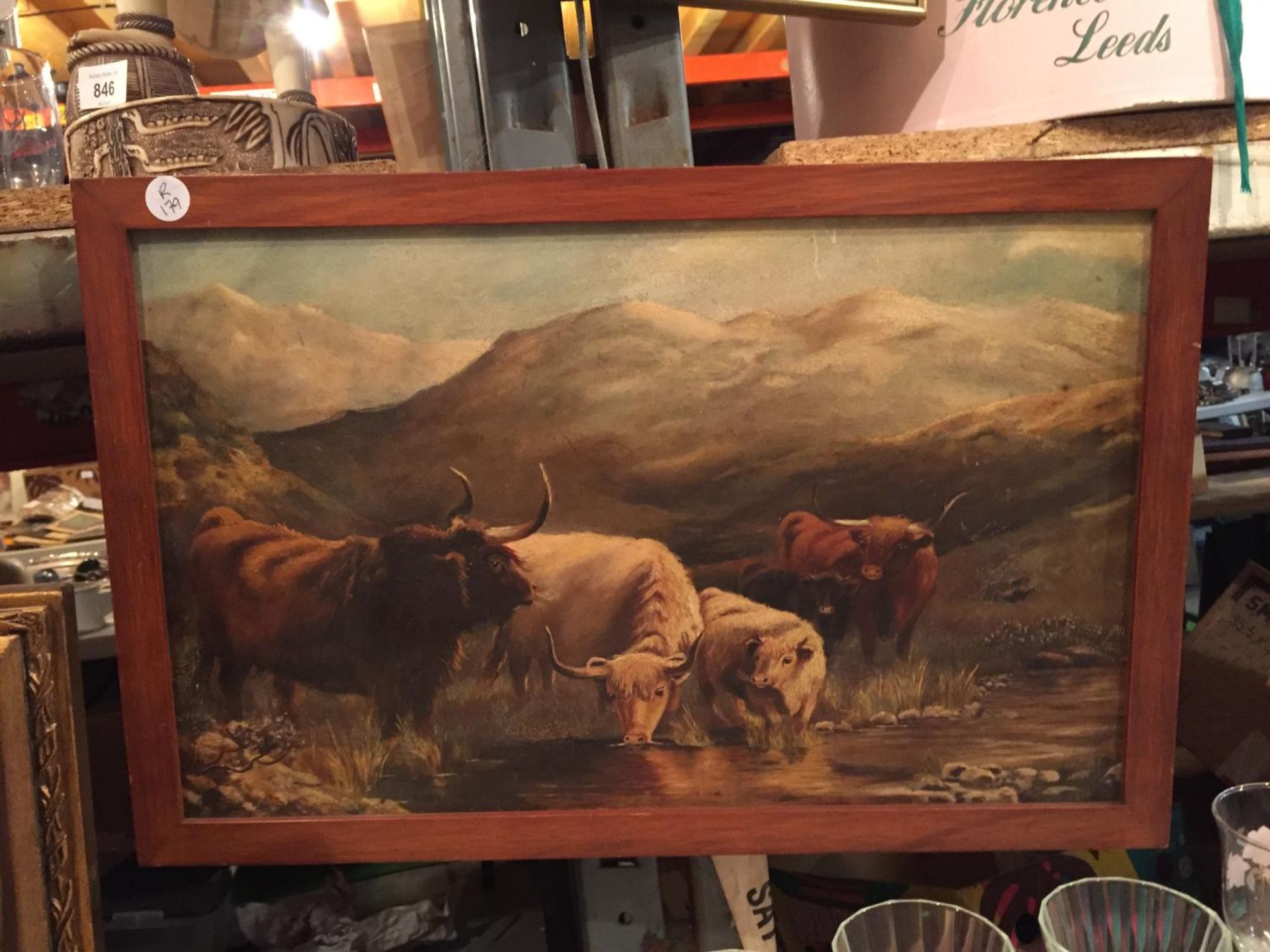 A WOODEN FRAMED PICTURE OF CATTLE AT A RIVER