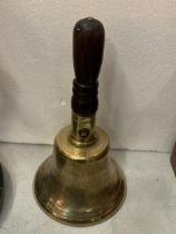 A VINTAGE BRASS HAND BELL WITH MILITARY ARROW