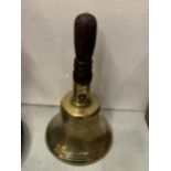 A VINTAGE BRASS HAND BELL WITH MILITARY ARROW