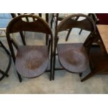 A PAIR OF FOLDING CHAIRS WITH EMBOSSED DECORATION TO THE BACK AND SEAT