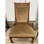 AN EDWARDIAN OAK LOW NURSING CHAIR