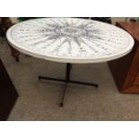 A MODERN COFFEE TABLE 33" DIAMETER, THE TOP IS DECORATED WITH NAVIGATION SYMBOLS