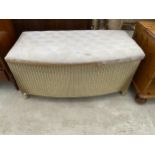 A LLOYD LOOM OTTOMAN ON CABRIOLE LEGS, 36" WIDE