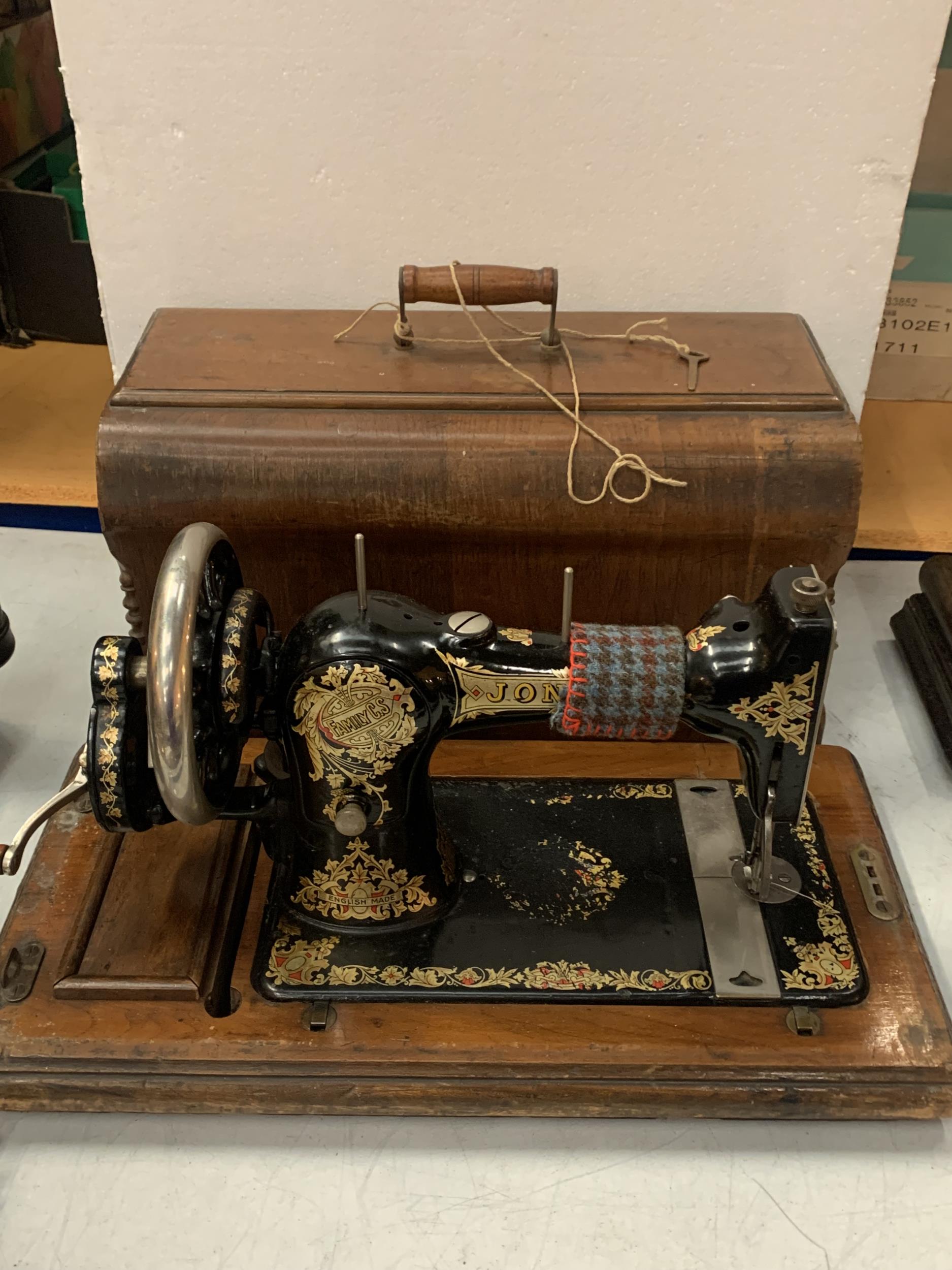 A VINTAGE CASED JONES SEWING MACHINE