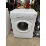 A WHITE HOTPOINT WASHING MACHINE