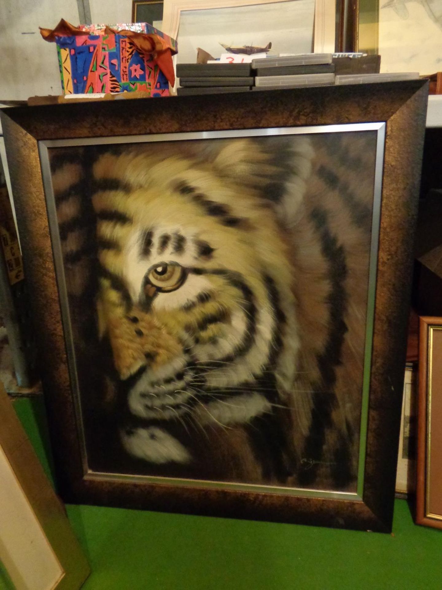 A FRAMED PAINTING ON BOARD OF A TIGER