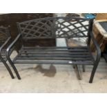 A METAL SLATTED GARDEN BENCH WITH FLORAL BACK