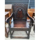 A 17TH CENTURY OAK JOINED ELBOW CHAIR, HAVING CARVED BACK AND INLAID PANEL, ON TURNED LEGS