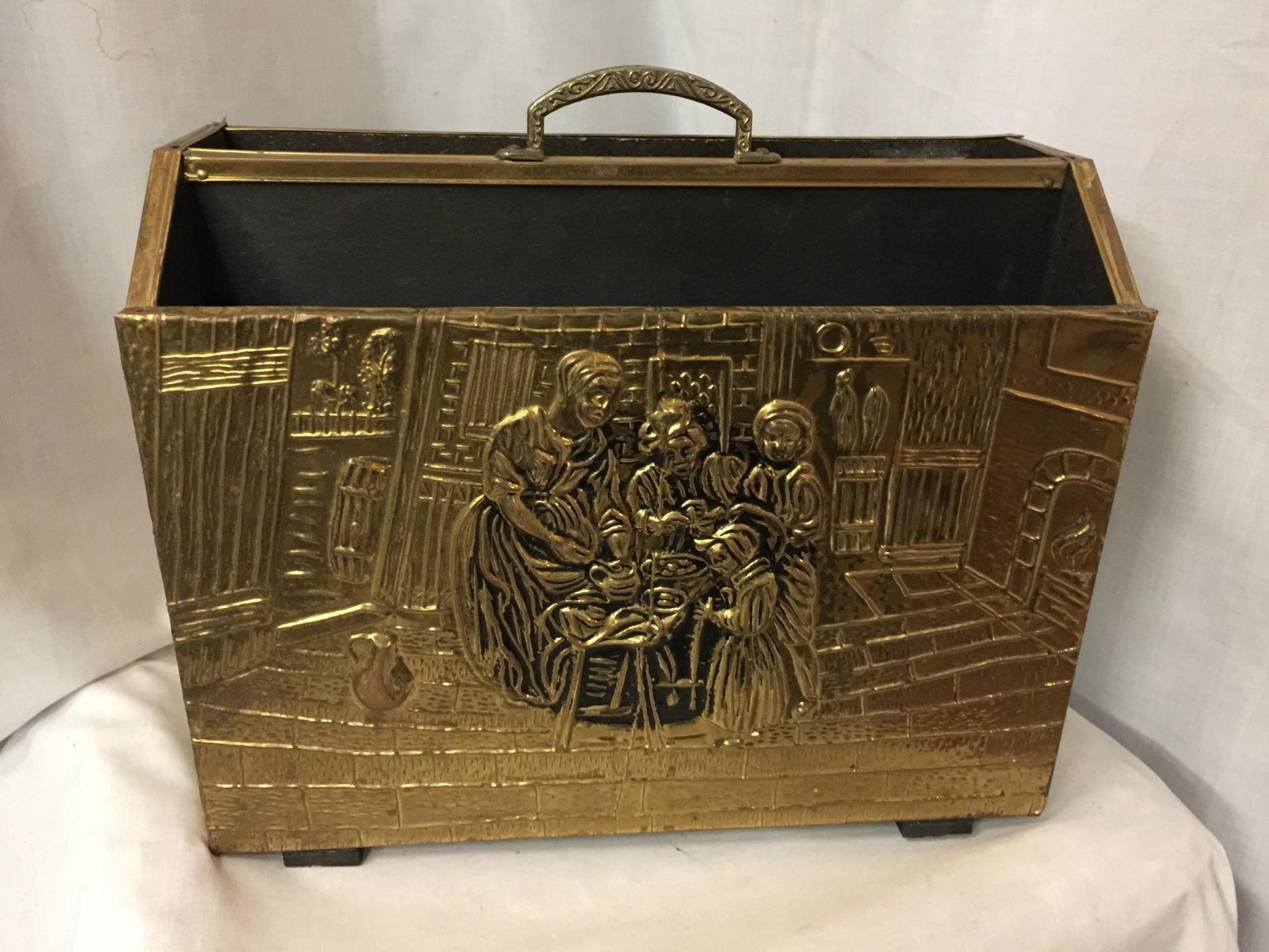 A BRASS TWO SECTIONAL MAGAZINE RACK DEPICTING FAMILY KITCHEN SCENE