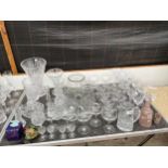 A LARGE QUANTITY OF GLASS WARE TO INCLUDE CUT GLASS VASES, WINE GLASSES AND TANKARD ETC