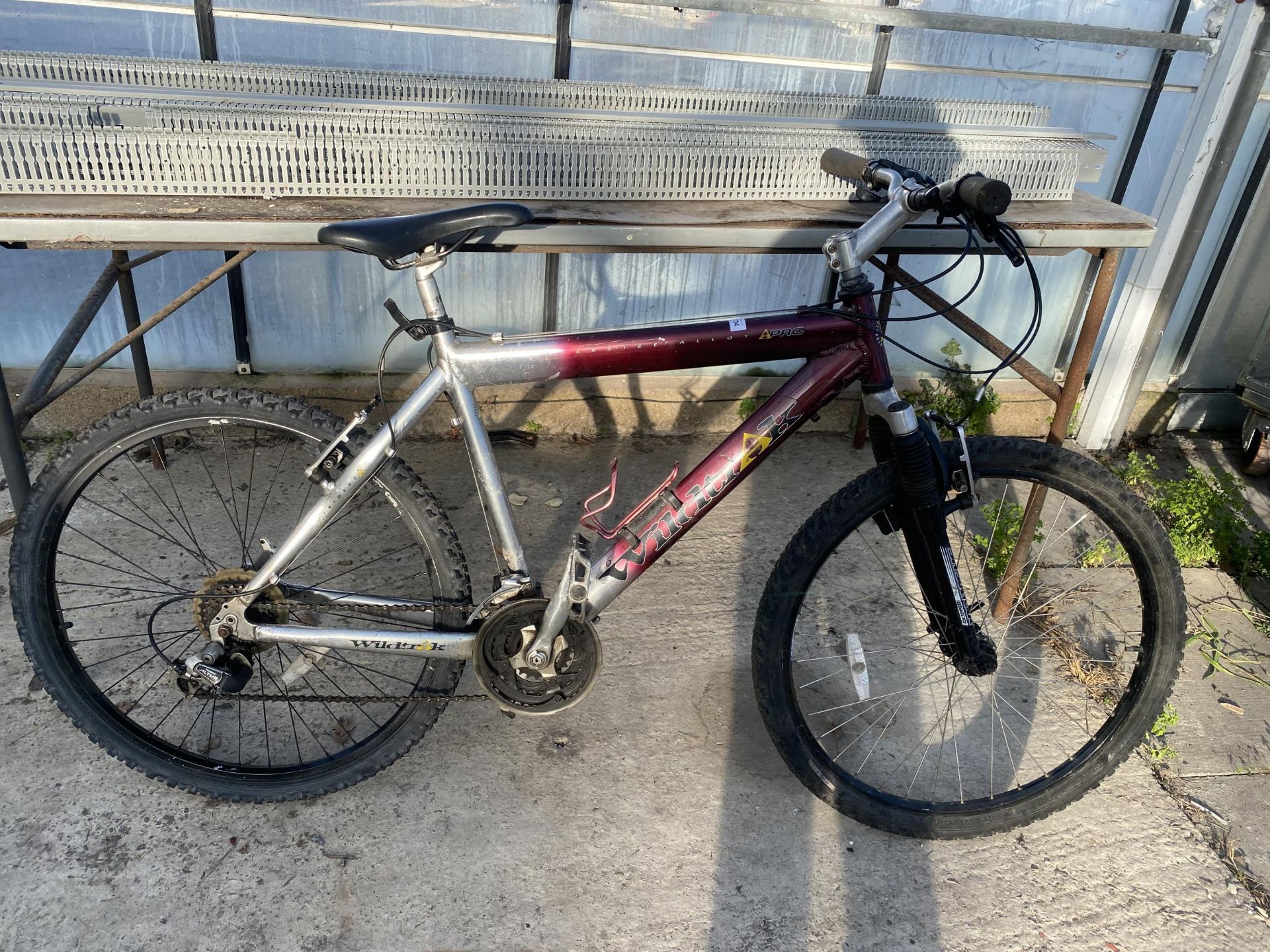 A WILDTRAK GENTS MOUNTAIN BIKE WITH FRONT SUSPENSION AND 12 SPEED SHIMANO GEAR SYSTEM