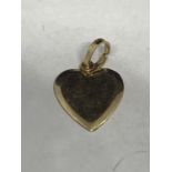 A TESTED TO 14 CARAT GOLD HEART SHAPED CHARM GROSS WEIGHT 0.9 GRAMS