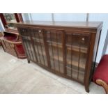 AN EARLY 20TH CENTURY OAK FOUR DOOR GLAZED CABINET, 71" WIDE