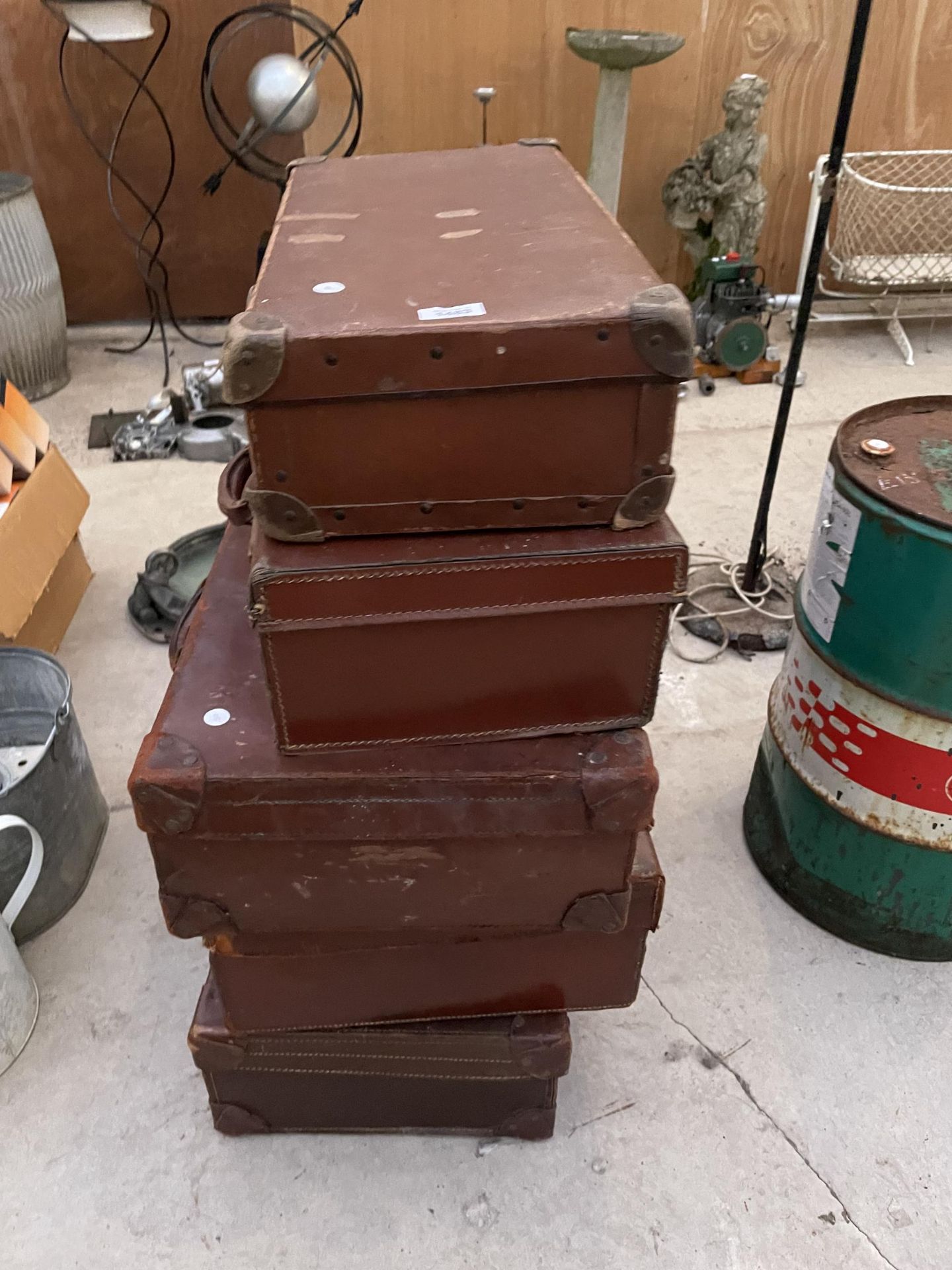 A COLLECTION OF FIVE VARIOUS SIZED VINTAGE LEATHER SUITCASES