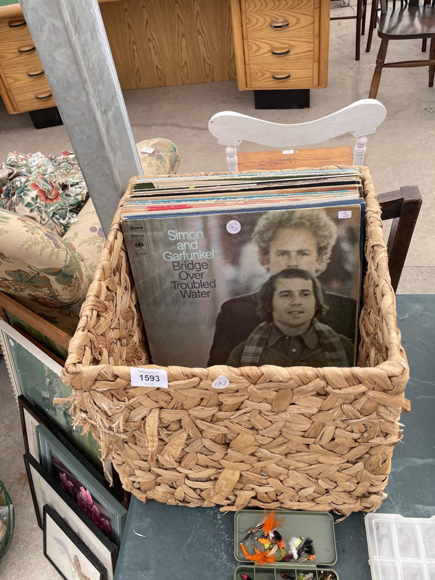 A WICKER BASKET WITH AN ASSORTMENT OF LP RECORDS