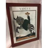 A MIRROR WITH A PICTURE OF A LADY ON A ZEBRA ADVERTISING VOGUE