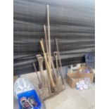 A LARGE ASSORTMENT OF GARDEN TOOLS TO INCLUDE SPADES, RAKES AND FORKS ETC