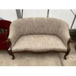 A VICTORIAN WALNUT TWO SEATER COUCH WITH SERPENTINE FRONT AND SCROLL ARMS, ON FRONT CABRIOLE LEGS,