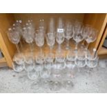 AN ASSORTMENT OF GLASS WARE TO INCLUDE WINE GLASSES, CHAMPAGNE FLUTES AND SHERRY GLASSES ETC