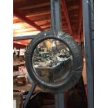 A ROUND PEWTER ARTS AND CRAFTS STYLE MIRROR