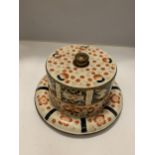 A VINTAGE STYLE CHEESE PLATE AND DOME IN A CREAM, ORANGE AND BLUE PATTERN