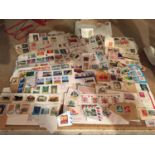 A QUANTITY OF FIRST DAY COVERS AND LOOSE STAMPS