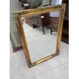 A MODERN GILT FRAMED WALL MIRROR, 42 X 30"