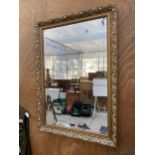 A DECORATIVE GILT FRAMED MWALL MIRROR