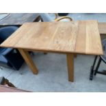 A MODERN OAK DROP-LEAF DINING TABLE