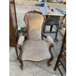 A VICTORIAN WALNUT FIRESIDE CHAIR WITH OPEN ARMS, ON CABRIOLE LEGS