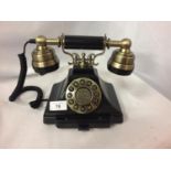 A VINTAGE STYLE BLACK AND BRASS PUSH BUTTON TELEPHONE WITH A PULL OUT NUMBER TRAY