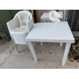A WHITE PLASTIC GARDEN FURNITURE SET TO INCLUDE A TABLE AND SEVEN CHAIRS