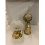 TWO BRASS OIL LAMPS ONE WITH AN ETCHED GLASS DOME