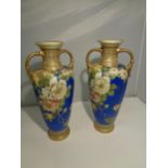 A PAIR OF BLUE NORITAKE URNS WITH GILT DETAILING AND FLORAL DESIGN