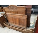 AN OAK ART NOUVEAU 4' BEDSTEAD WITH CARVING TO THE ROP RAILS