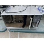 A SILVER KENWOOD MICROWAVE OVEN