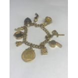A 9 CARAT GOLD CHARM BRACELET WITH NINE CHARMS TO INCLUDE A 1900 VICTORIA GOLD SOVEREIGN IN A