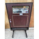 A VINTAGE AND RETRO CIGARETTE VENDING MACHINE WITH ORIGINAL FEATURES AND COMPLETE COIN MECHANISM AND